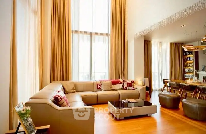 Luxurious living room with high ceilings and elegant decor in modern apartment.