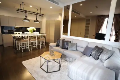 Modern open-layout living room with stylish kitchen and cozy seating area