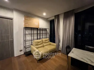 Modern living room with leather sofa and city view, featuring elegant wooden flooring and stylish decor.