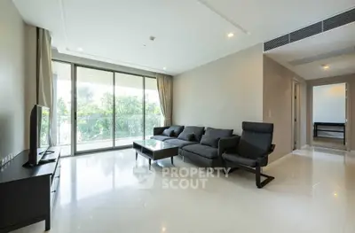 Spacious modern living room with large windows and sleek furniture