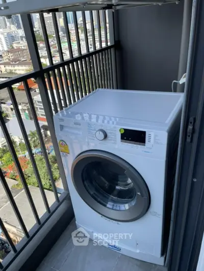 Modern washing machine on a high-rise balcony with city view, perfect for urban living convenience.