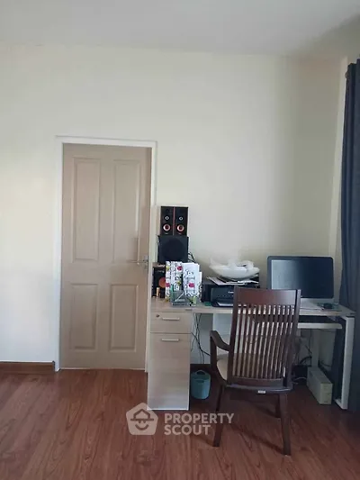 Cozy study room with wooden flooring and modern desk setup