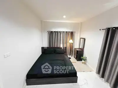 Modern minimalist bedroom with black bed and stylish decor