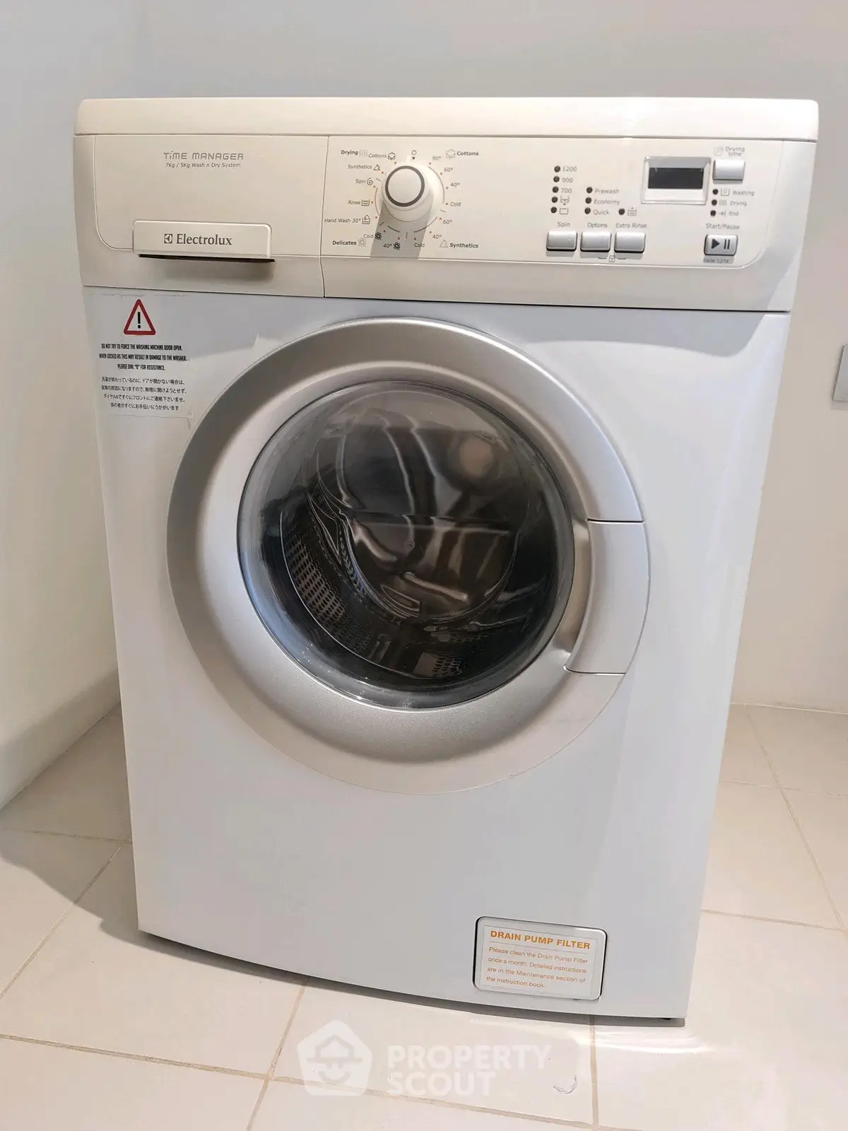 Modern Electrolux washing machine in a sleek laundry room setting.
