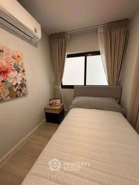 Cozy small bedroom with air conditioning and floral decor