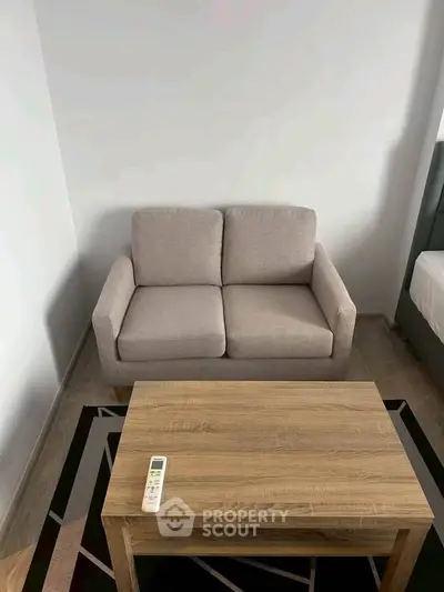 Cozy living room with modern sofa and wooden coffee table, perfect for relaxation.