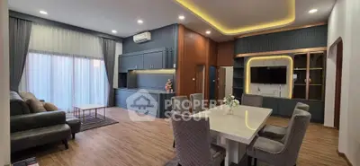 Luxurious open-plan living and dining area with modern furnishings and elegant lighting.