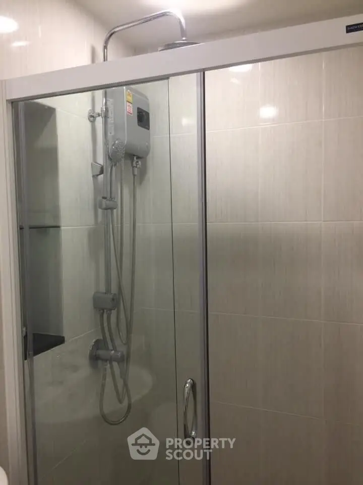 Modern bathroom with glass shower enclosure and sleek fixtures