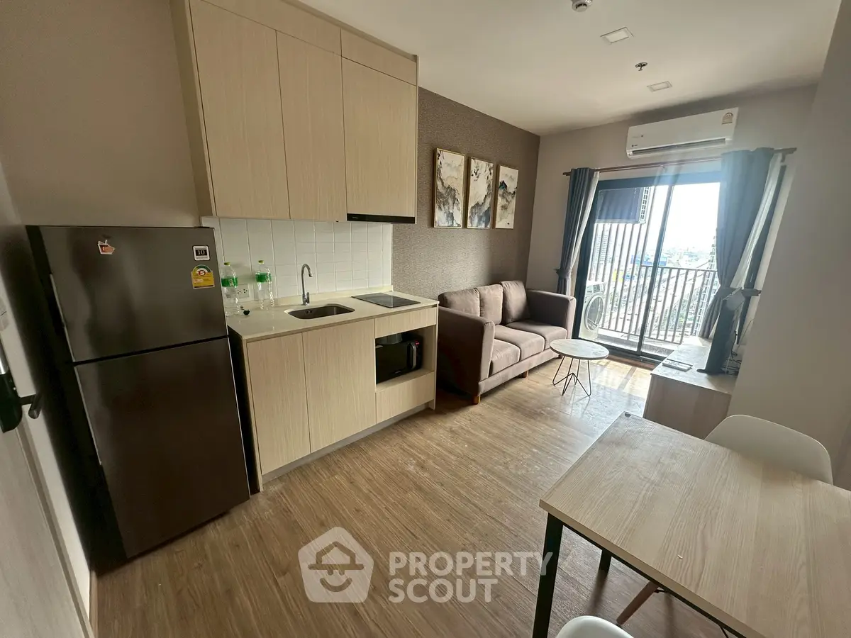 Modern apartment living room with open kitchen and balcony view