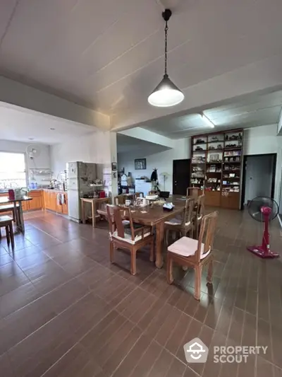 Spacious kitchen with open layout, ample cabinetry, and modern appliances, seamlessly transitioning to a cozy dining area with natural light.