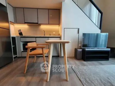 Modern open-layout kitchen and living area with sleek furniture and stylish design.