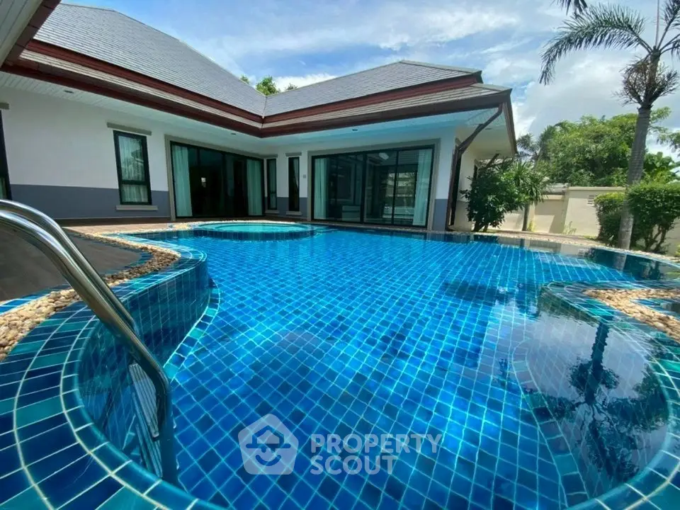 Luxurious villa with private pool and modern architecture in tropical setting.