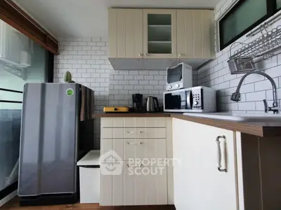 Modern kitchen with stainless steel appliances and white cabinetry