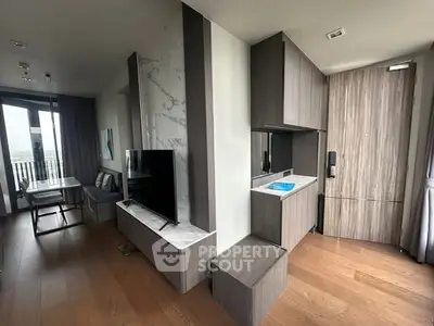 Modern living room with sleek wooden flooring and stylish furniture, featuring a TV and dining area.