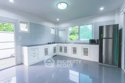 Spacious modern kitchen with sleek appliances and ample natural light