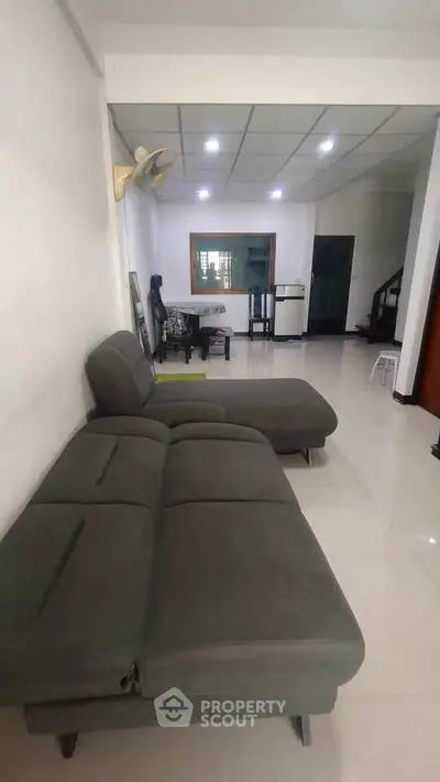 Spacious living room with modern sofa and sleek flooring