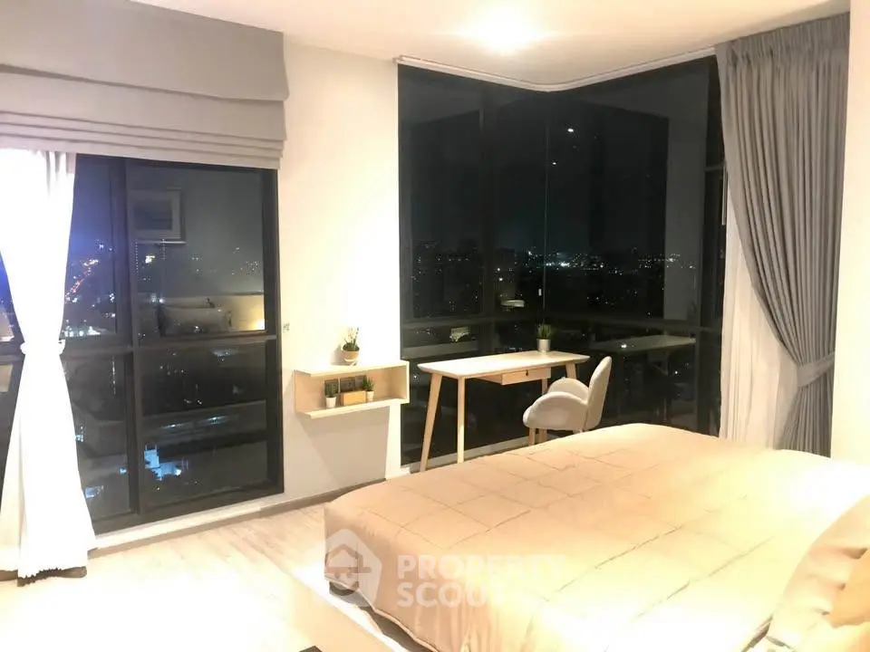 Luxurious bedroom with stunning city view, modern furnishings, and elegant decor.