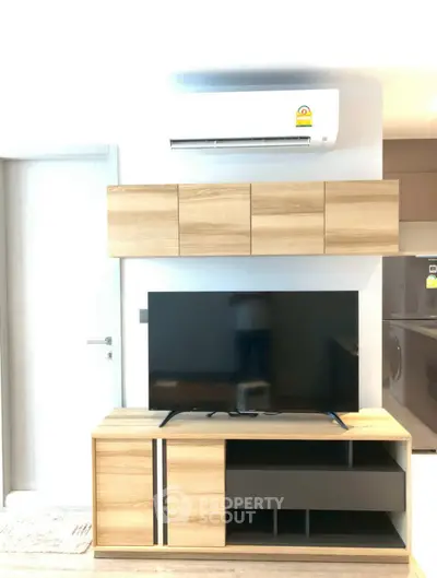 Modern living room with sleek TV stand and air conditioning unit