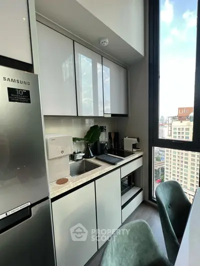 Modern kitchen with sleek cabinetry and city view from window