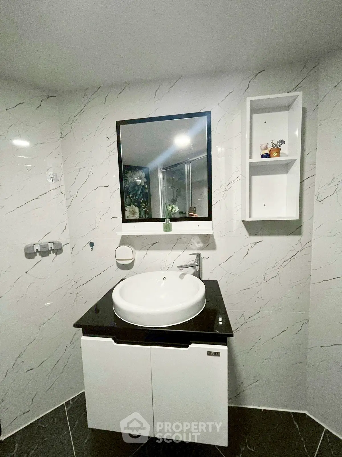 Modern bathroom with sleek vanity and marble walls