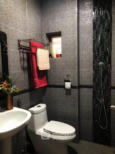 Modern bathroom with sleek tile design and contemporary fixtures.