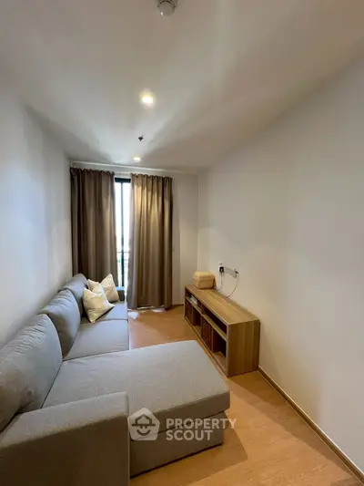 Cozy living room with modern sofa and natural light from window