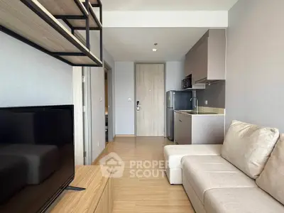 Modern studio apartment with open layout, featuring a cozy living area and compact kitchen.