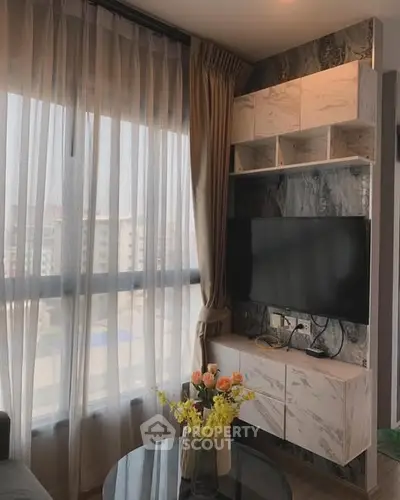 Modern living room with large window and stylish TV setup