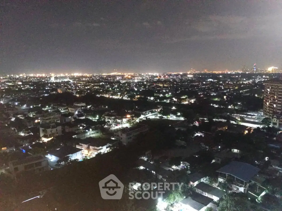Stunning night cityscape view from a high-rise building showcasing vibrant city lights and expansive skyline.