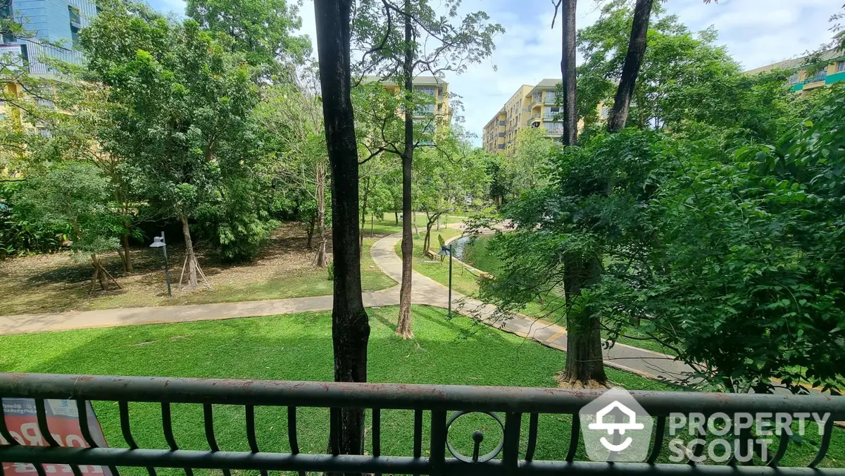 Serene park view from a spacious balcony, offering a tranquil outdoor space for relaxation amidst lush greenery in a vibrant neighborhood.