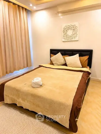 Cozy bedroom with elegant decor and soft lighting, featuring a comfortable bed and stylish curtains.