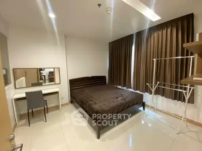 Modern bedroom with sleek furniture and large window, perfect for urban living.