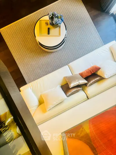 Luxurious living room with elegant decor and plush white sofa