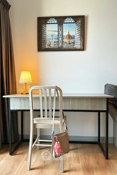Cozy study area with desk, chair, and decorative wall art