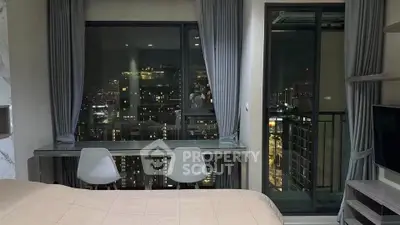 Modern bedroom with stunning city view and balcony access, featuring sleek furniture and elegant decor.