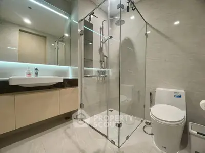 Modern bathroom with glass shower enclosure and sleek fixtures
