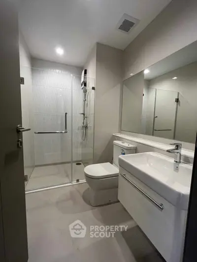 Modern bathroom with glass shower and sleek fixtures