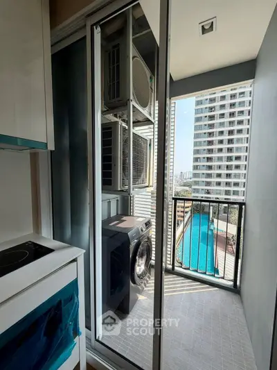 Modern apartment balcony with pool view and washing machine setup