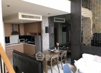 Modern open-plan kitchen and dining area with sleek design and contemporary furniture.