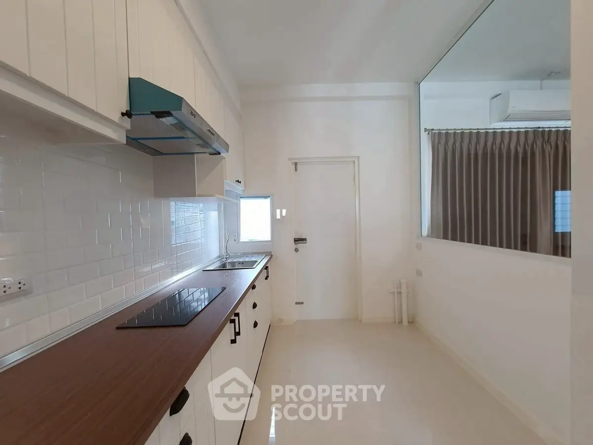 Modern kitchen with sleek cabinetry and built-in appliances in a bright, minimalist design.