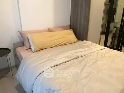 Cozy bedroom with modern decor and plush bedding in a stylish apartment.