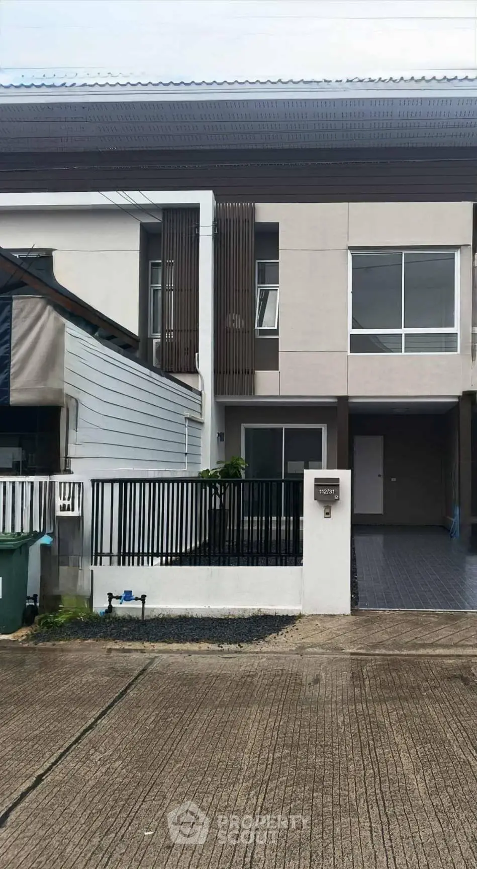 Modern townhouse exterior with sleek design and spacious driveway