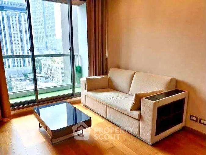 Modern living room with city view, featuring a cozy sofa and sleek coffee table.