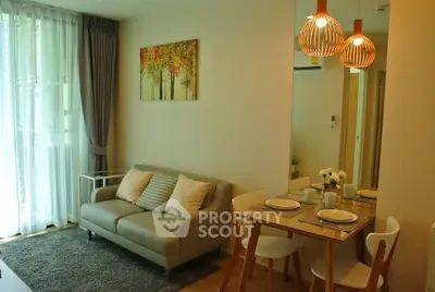 Cozy living room with dining area and modern decor in a stylish apartment.