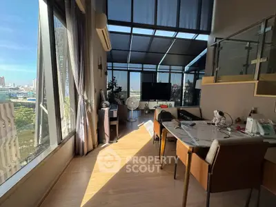 Spacious modern living room with large windows and city view