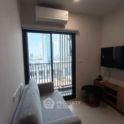 Modern living room with city view, featuring a sleek sofa, wall-mounted TV, and air conditioning.
