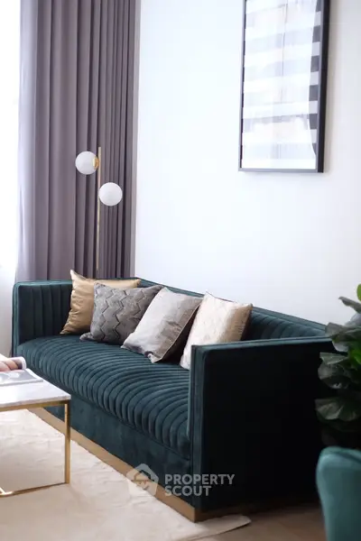 Elegant living room with plush green sofa and stylish decor