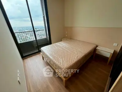 Modern bedroom with balcony view in high-rise apartment