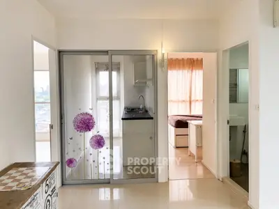 Modern apartment interior with open layout, featuring a compact kitchen and cozy bedroom.