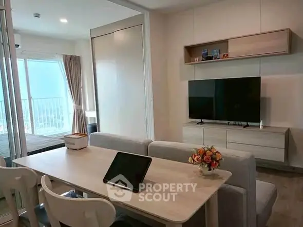 Modern living room with sleek furniture and balcony view, perfect for urban living.